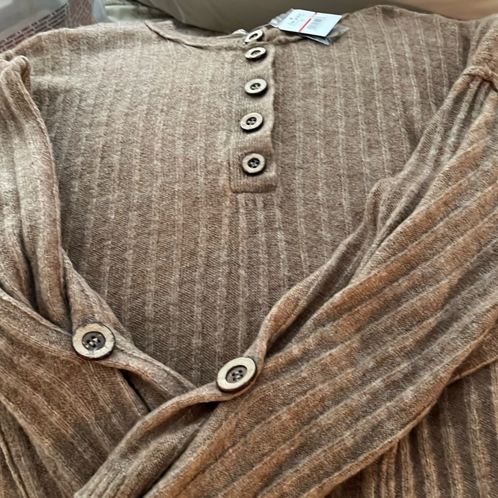 Cozy, soft tan sweater with extra buttons.  Acrylic, nylon and spandex